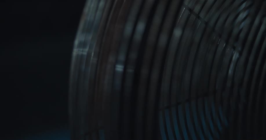 A fan is on in a dark room