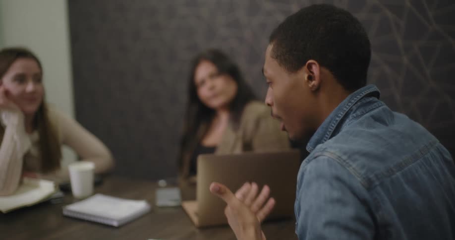 A man is speaking at an office meeting