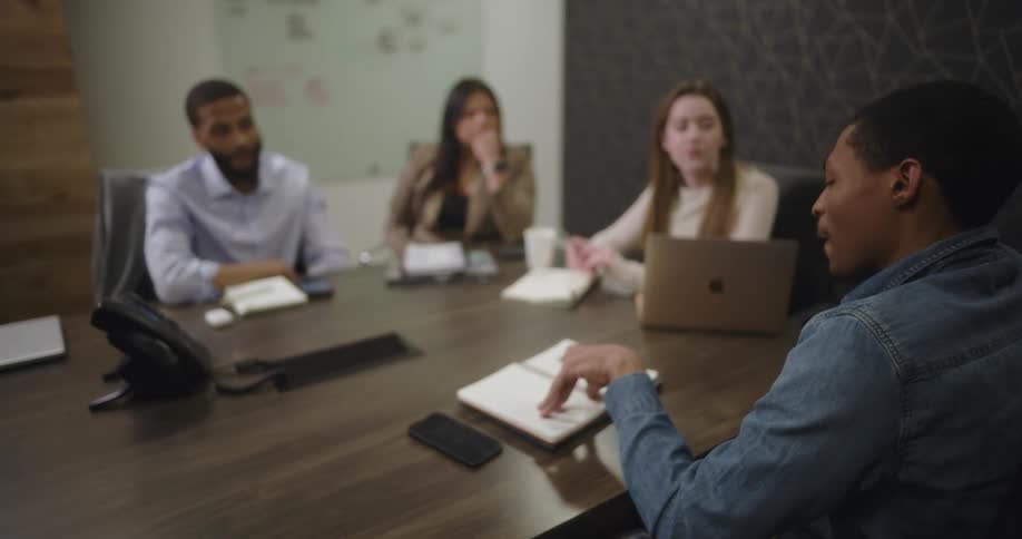 Co workers are talking in the office during a meeting
