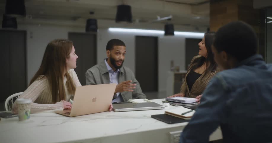 People point and talk at a meeting in the office
