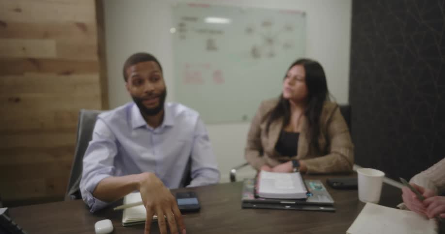 Coworkers sit in a conference room during a meeting