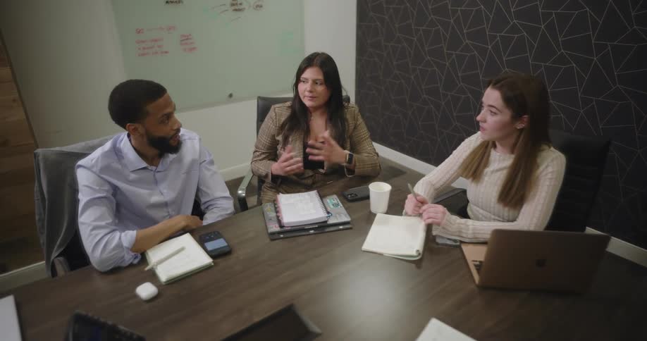 A woman has a discussion at a meeting