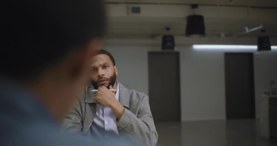 Coworkers sit at a table in an office and hold a meeting