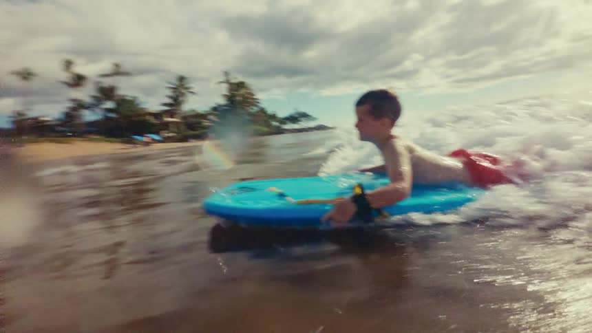 A footage of a boy surfing the sea