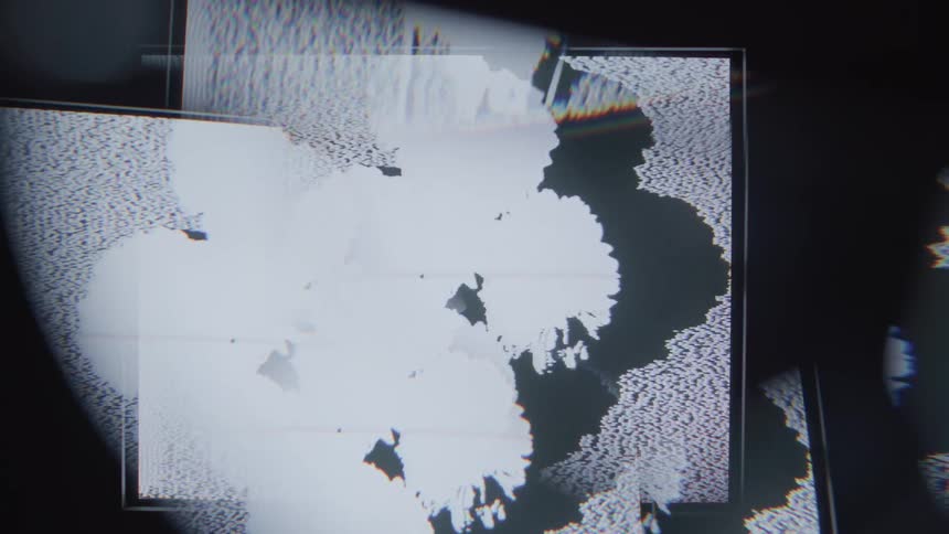 A closeup of a screen reveals pixelated abstract shapes and patterns