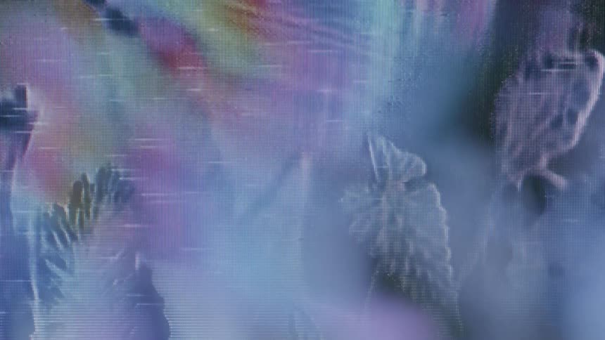 A closeup of a screen reveals pixelated abstract shapes and patterns in blue and purple tones