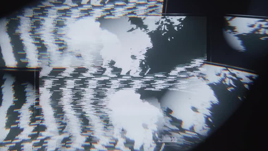A distorted staticfilled image displays fragmented patterns of light and dark areas