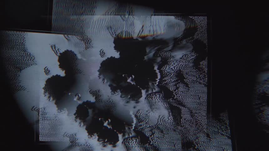 A closeup of a screen reveals pixelated abstract shapes and patterns