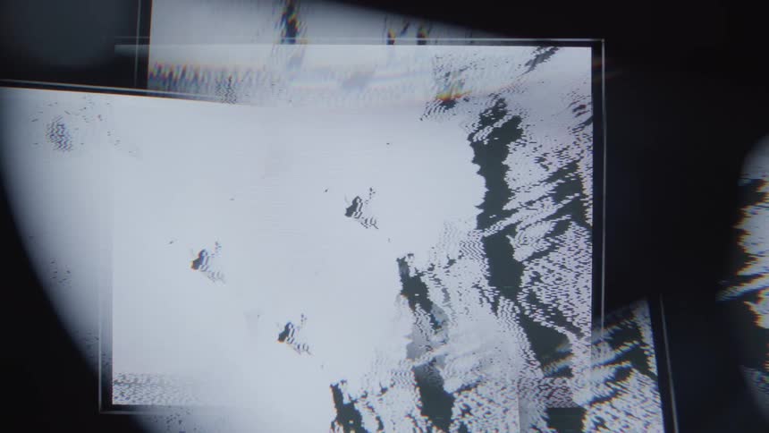 A closeup of a screen reveals pixelated abstract shapes and patterns