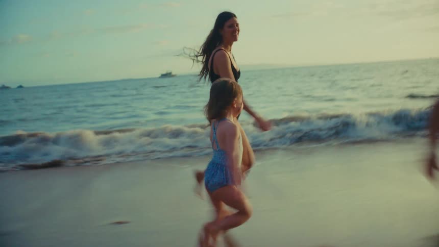 Mom playing with her children on the beach