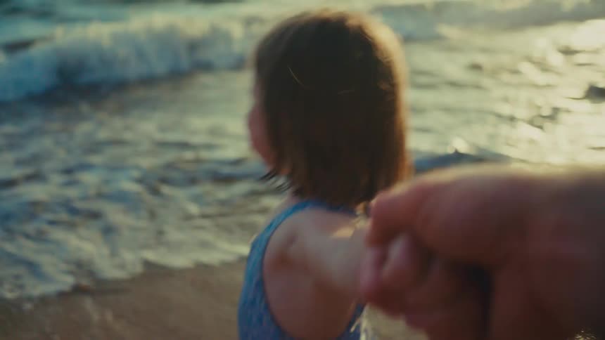 A girl is happy walking on the shore line