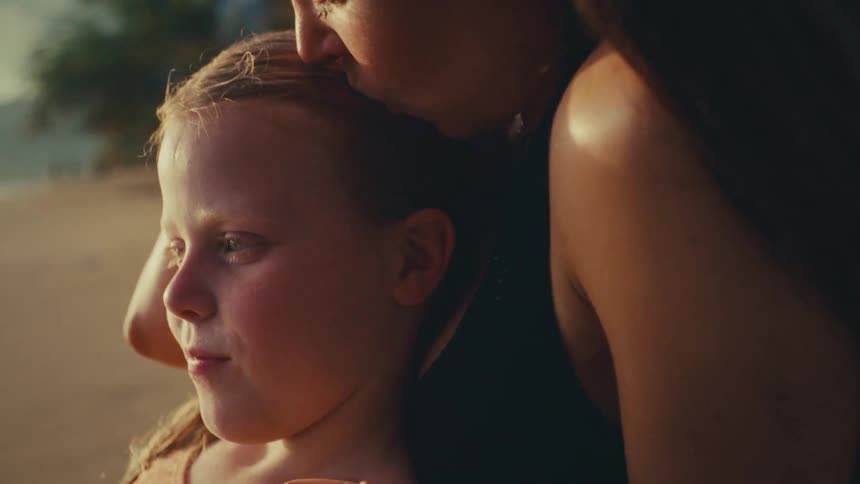Mom patting her daughter on the head