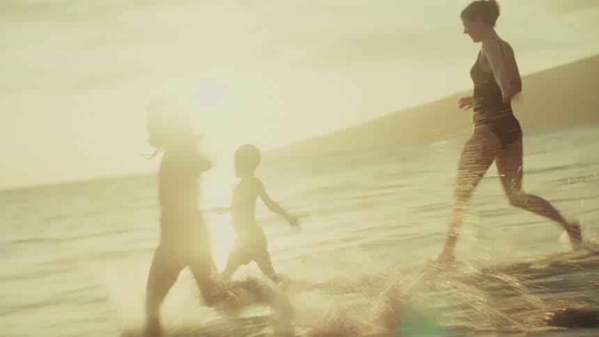 Running Into the Ocean Together in a Moment of Family Joy