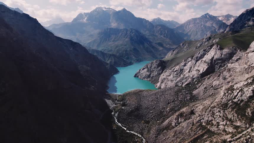 Aerial of a blue lake hidden in the valley of a canyon