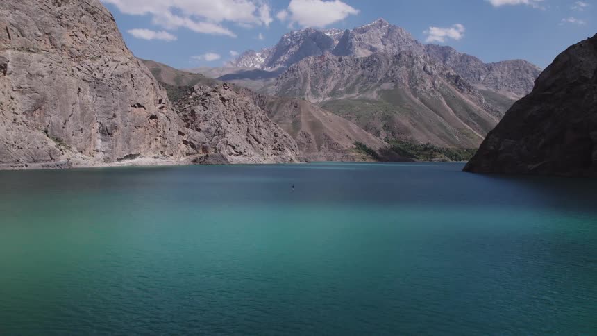 A large blue lake is by the mountains