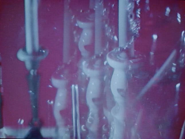 The candlestick is reflected in the light