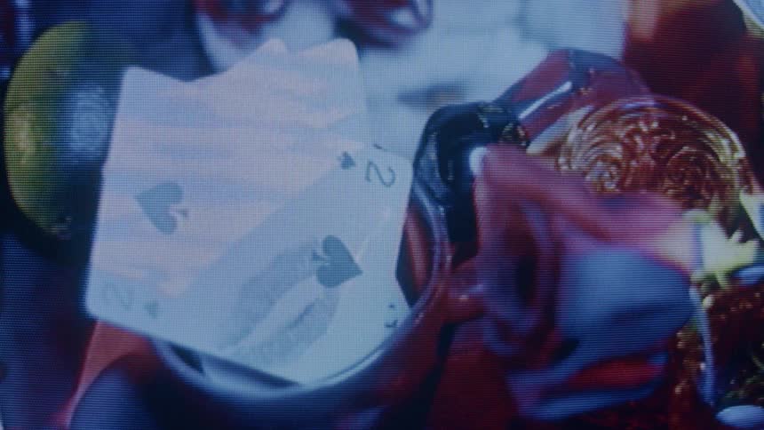Cards inside a cup with a flower