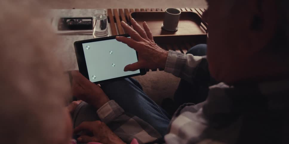 A footage of older people operating a tablet