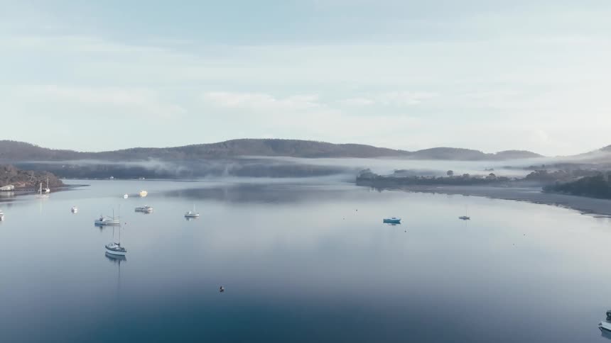Aerial view of a large lake with boats