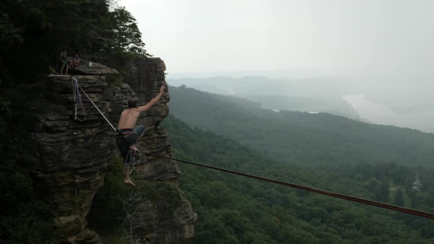 A person doing tricks on a tightrope