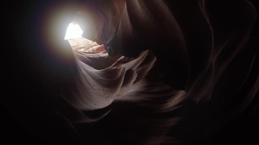 Sunshine peeking through a hole in a cavern