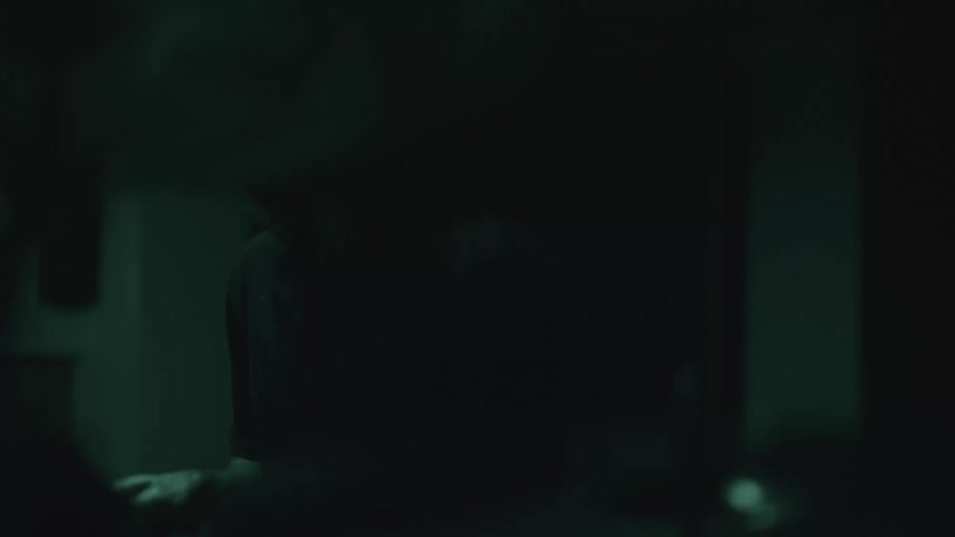 The man shakes his head around as he plays the drums