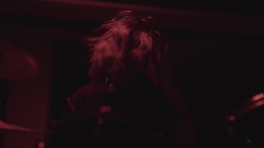 Drummer playing by shaking his hair