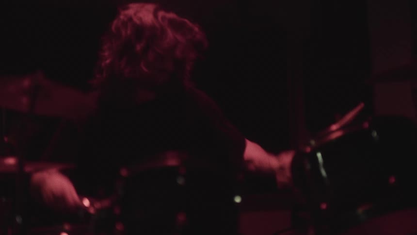 The man is hitting the drums fast at the event