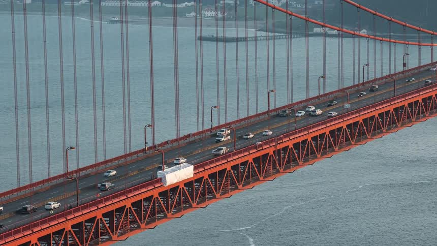 An aerial clip of cars moving on a bridge