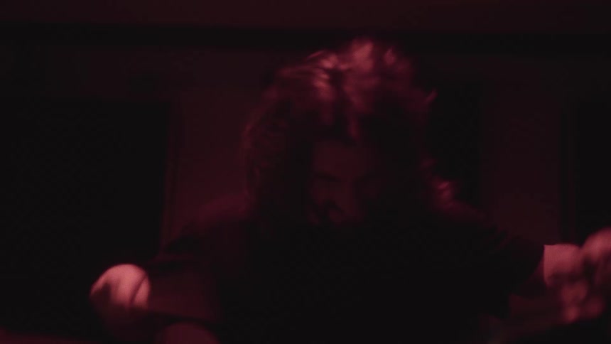 A musician is playing the drums