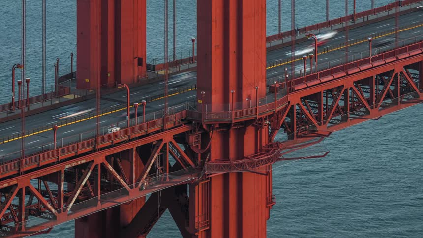 An aerial static time lapse view of cars traveling along the golden gate bridge