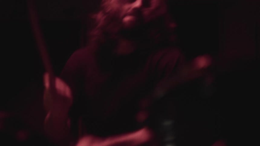 A drummer uses his drumsticks to aggressively play the drums