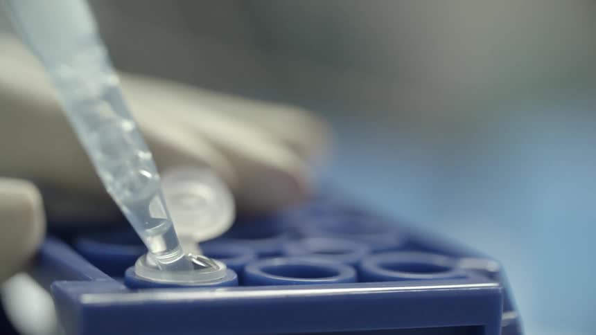 A person removes some water with a syringe