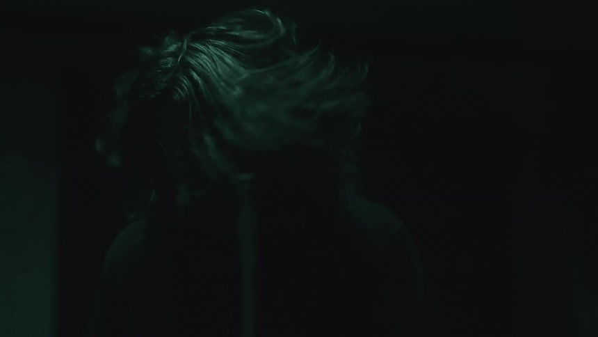 A man is happy while playing the drums in the dark slow motion