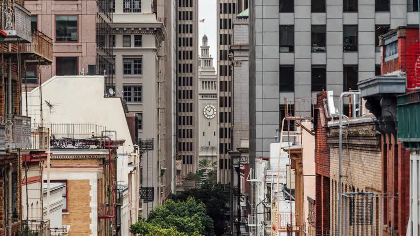 A city street ending in a clock tower