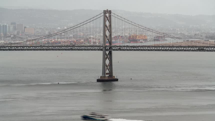 View of a bridge in a large city with many cars passing by