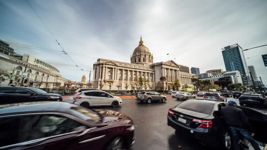 People are vehicles travel around the landmark building