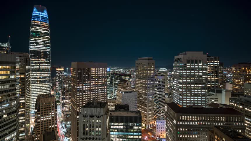 Lights flash in the windows of the city buildings at night