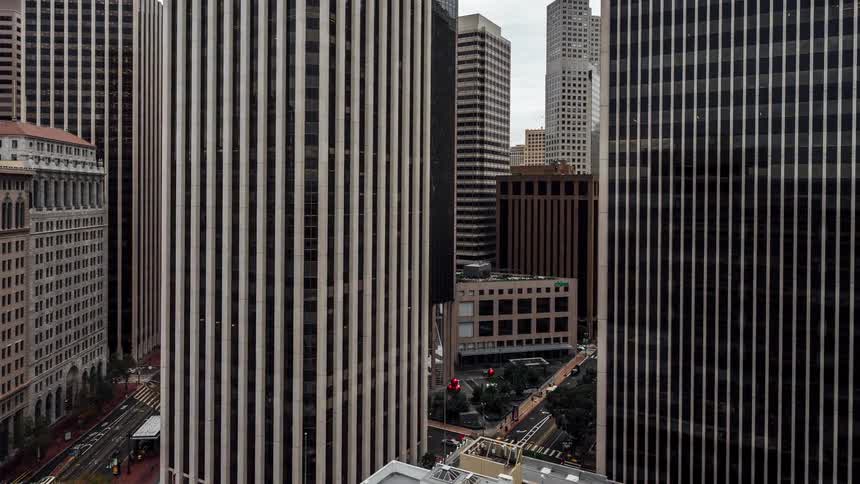 Aerial view of a cluster of tall buildings with vertical striped facades in an urban setting in san francisco based on the mention of 44 montgomery street