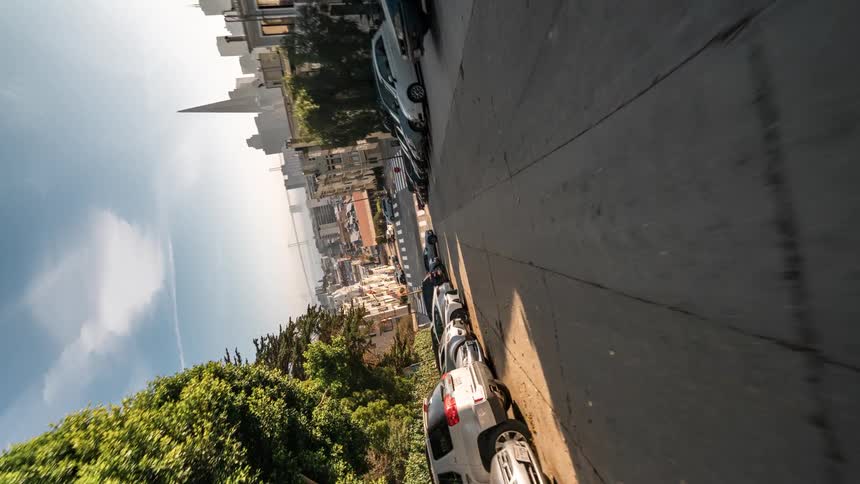 Cars drive by on the road in town