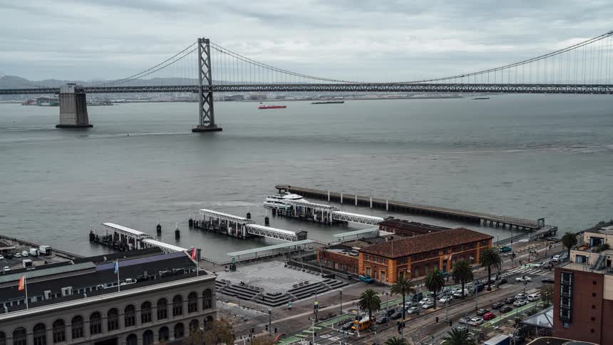 View of a large busy city with a bridge