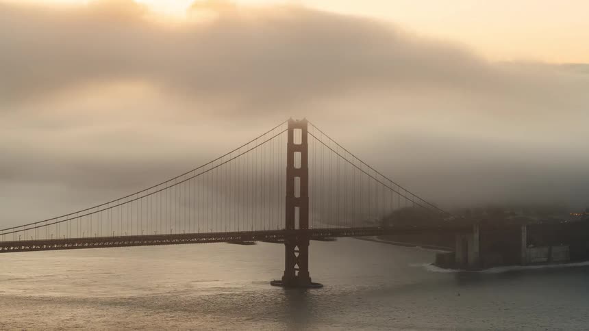 Landscape of a bridge in a big city with changing sea and sky
