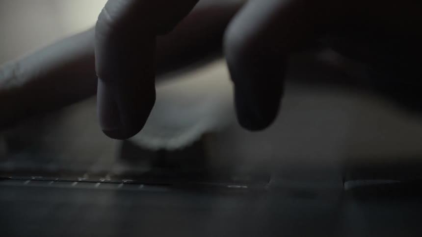 A person pushes up a fader on audio mixing console