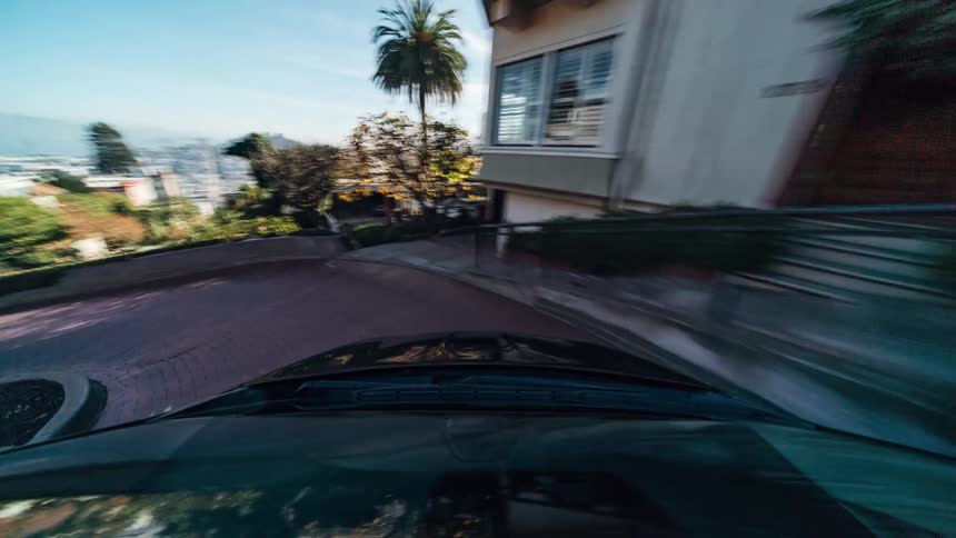 A thrilling fast motion ride in a car that descends lombard street in san francisco