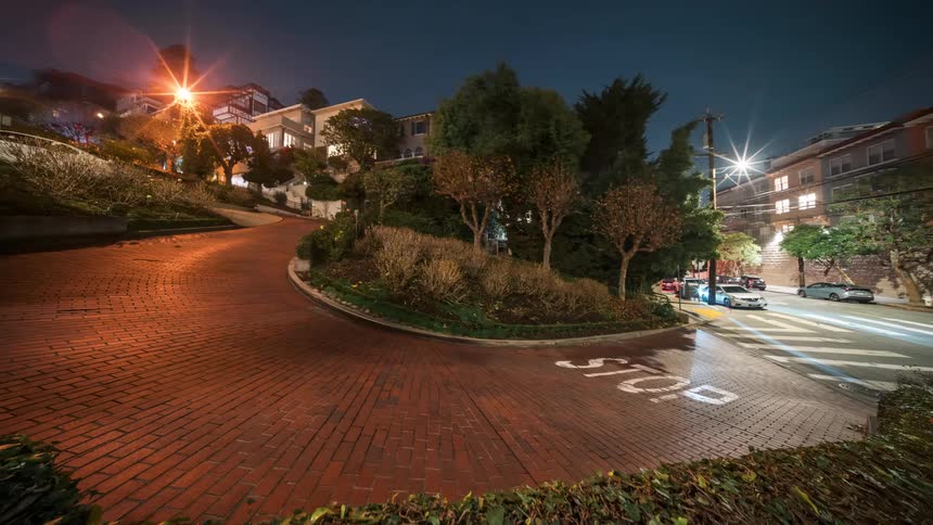 Cars driving on a winding road in the neighborhood