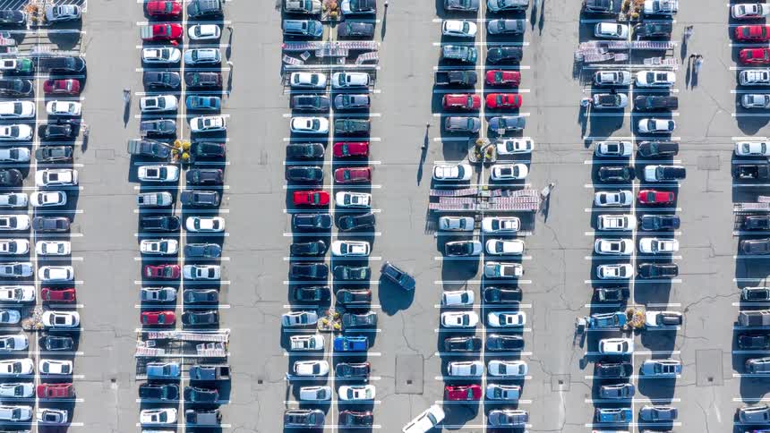 Rising hyperlapse of an extremely busy shopping center parking lot bustling with activity