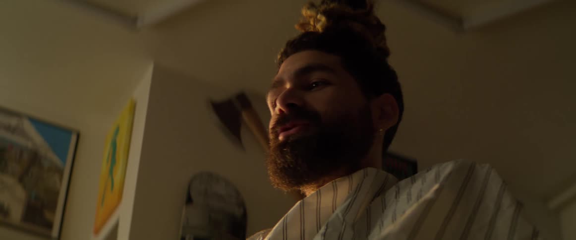 A customer talks while the barber works