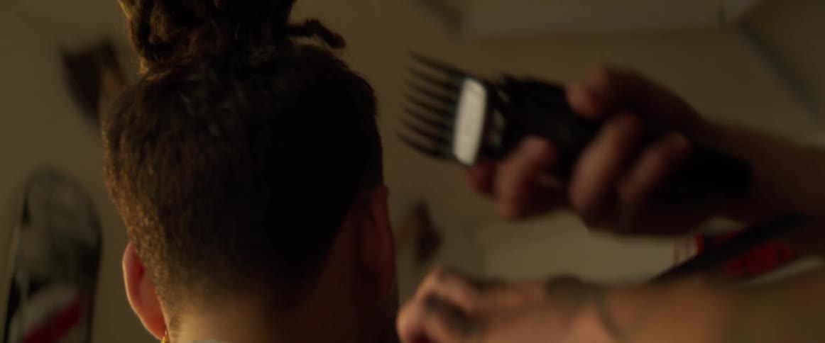 Boy whose hair is cut with a razor