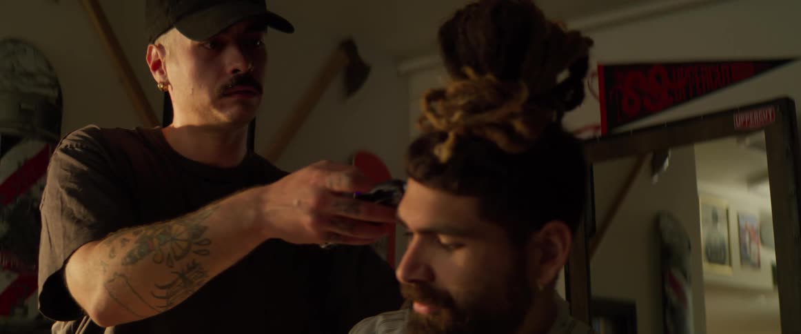 A man is getting his haircut at the barber