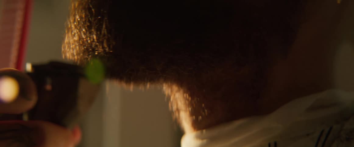 The barber is shaving a mans beard